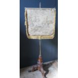 A Victorian Carved Pole Screen with needlework screen