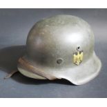 A WWII Kriegsmarine M40 Single Decal Helmet, size 56, stamped NS64 03 and pen marked Huber