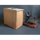 A Wilcox & Gibbs Sewing Machine, serial no. 206319, in pine case