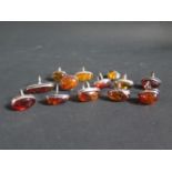 A Collection of Silver Mounted and White Metal Amber Rings