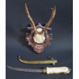 A Small Set of Mounted Horns on a carved back 'Schloss Tannhauseb October 1945' and a Middle Eastern
