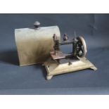 A Leigh & Crawford Sewing Machine and cover