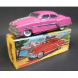 A Minister Delux Fiction Tinplate Toy Car in Deep Pink. Near mint in worn box.