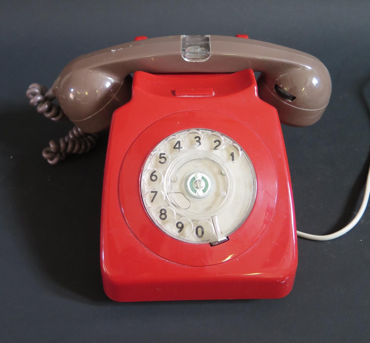 A Red Telephone with brown hand set