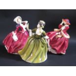 Three Royal Doulton Figurines: HN1934 Autumn Breezes, HN1834 Top o'the Hill and HN2378 Simone