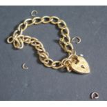 A 9ct Gold Curb Link Bracelet with heart clasp, 15.6g