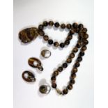 A Chinese Tiger's Eye Bead Necklace with carved pendant, pendant 52mm, 18mm beads, 65cm long, silver