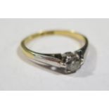 An 18ct Gold and Platinum Diamond Set Solitaire Ring, size M.5, 2.3g (EDW .2ct)