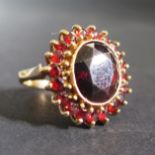 A 9ct Yellow Gold and Garnet Cluster Ring, 20mm head, size L, 6.4g