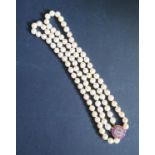 A Twin Strand Pearl Choker with a rose cut diamond and ruby clasp, the central stone with a