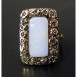 A Georgian White Opal Ring in a high carat unmarked gold setting decorated with shell and flower