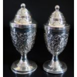 A Pair of Victorian Silver Urn Shaped Peppers with embossed acanthus leaf decoration, Birmingham