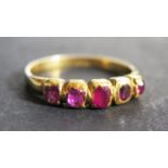 An 18ct Yellow Gold and Ruby Five Stone Ring, size T.5, 4.3g