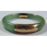 A Chinese Jadeite and 18K Gold Hinged Bangle