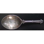 A Victorian Silver Festive Caddy Spoon decorated with a three stockings hanging by a fireplace and