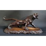 A Japanese Meiji Period Bonze Tiger with striped patina and glass eyes, signed to the base, 54cm