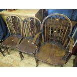 A Set of Three Elm Seated Wheel Back Carver Chairs including one carver