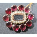 A Small Georgian Foil Backed Garnet and Seed Pearl Brooch in a yellow metal setting, 21x18mm