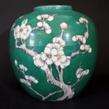 A Chinese Porcelain Prunus Decorated Vase on a green glazed ground, six character mark to base, 16cm