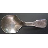 A Victorian Silver Caddy Spoon with chased foliate scroll decoration to the handle, Birmingham 1853,