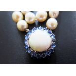 A Single Strand Pearl Necklace with a large white opal and blue stone pendant, the 15.5mm singlet
