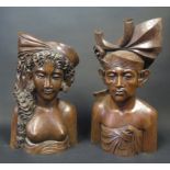 A Pair of Bali Carved Treen Busts of a female and male, signed KLUNGKUNG, tallest 34cm