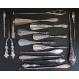 A Selection of Silver Handled Button Hooks, shoe horns and glove stretcher