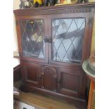 A Small Oak Leaded and Glazed Bookcase with cupboards below and an oak lap occasional table