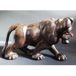 An Indian Carved Ebony and Bone Inlaid Lion, 25cm long