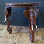 An Indian Carved Occasional Table with elephant mask legs, 61.5cm diam.
