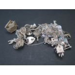 A Silver Charm Bracelet with 24 charms, 77.3g