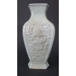 A Chinese Celadon Vase with moulded dragon decoration, 20.5cm high