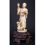 An Antique Japanese Ivory Okimono of a Man with Oni at Feet, carved from a single piece, signed to