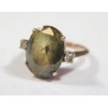 A Greenish Yellow Stone Ring flanked by diamonds, size L, 4.7g (stone 15x10mm)