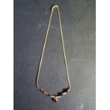 A 9ct Gold, Garnet and Diamond Necklace, 6.1g
