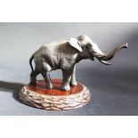 A Japanese Meiji Period Bronze Elephant, signed to the base, 17cm long and on carved wooden stand