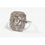 An Art Deco 18ct White Gold and Diamond Ring, size L.5, 3g (EDW .225ct), shank misshapen