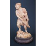 An Antique Japanese Ivory Okimono of Fisherman Casting his Nets, signed to the base, 15.8cm and on