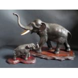 A Japanese Meiji Period Bronze Elephant and calf, with matching signatures to the base. The mother