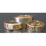 A 9ct Gold Two Tone Wedding Band (2.6g), a 14ct gold band (1.4g) and unmarked gold band (3.3g)