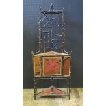 A Japanese Meiji Period Bamboo and Lacquered Corner Stand with single cupboard opening to reveal