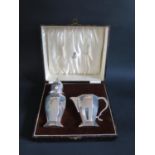 A Cased Silver Sugar Shaker and Cream Jug, Birmingham 1935/36, William Neale & Son Ltd., 262g