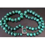 A Malachite Twin Strand Graduated Bead Necklace with a silver and paste clasp, largest 17mm diam.