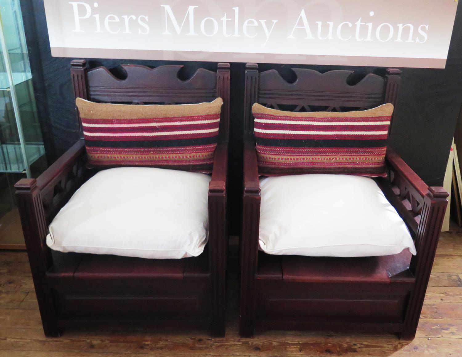 A Pair of African Armchairs with lift up storage sheets