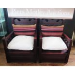 A Pair of African Armchairs with lift up storage sheets