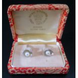 A Boxed Pair of Japanese Pearl Cufflinks in sterling silver settings by Sakarta Pearl Co.