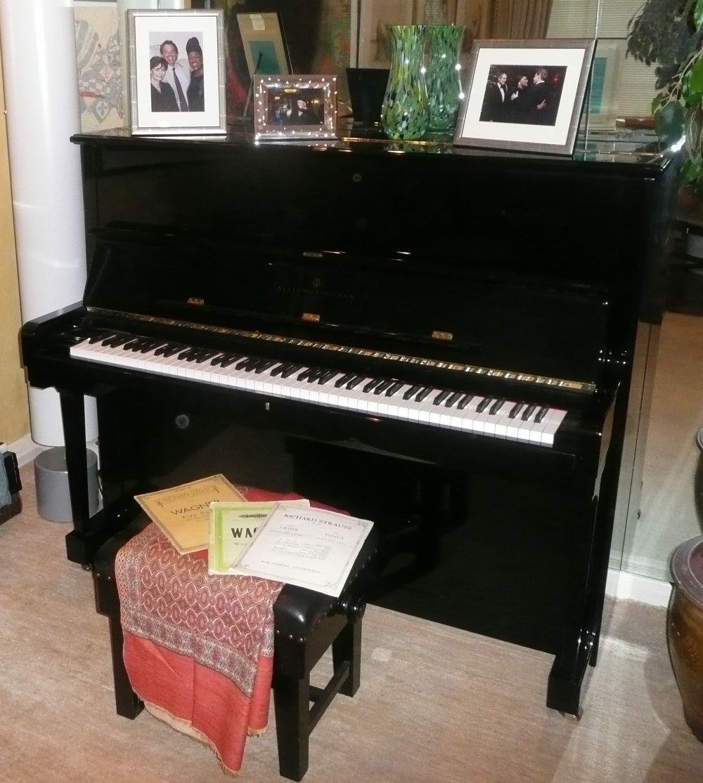 Steinway (c1993) A Model V upright piano in a bright ebonised case; together with a matching stool.