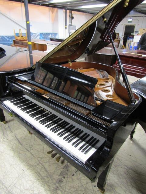 Kawai (c2010) A 5ft 10in Model RX2H grand piano in a bright ebonised case on square tapered legs.