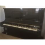 Steinway (c1920) An upright piano in an ebonised case; together with a duet stool.