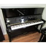 Yamaha (c1987) A Model U10BL upright piano in a bright ebonised case.